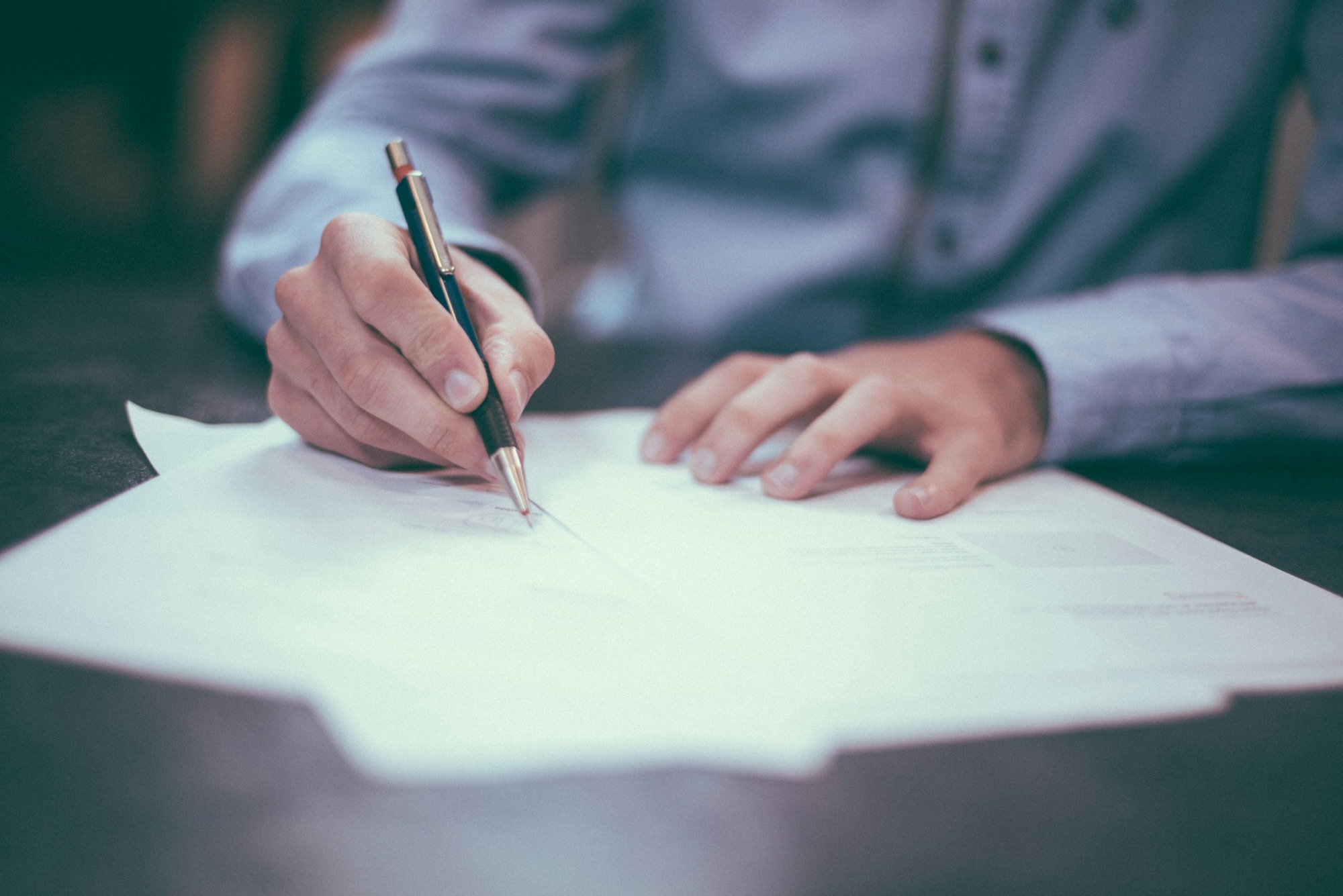 Close up of someone signing a contract