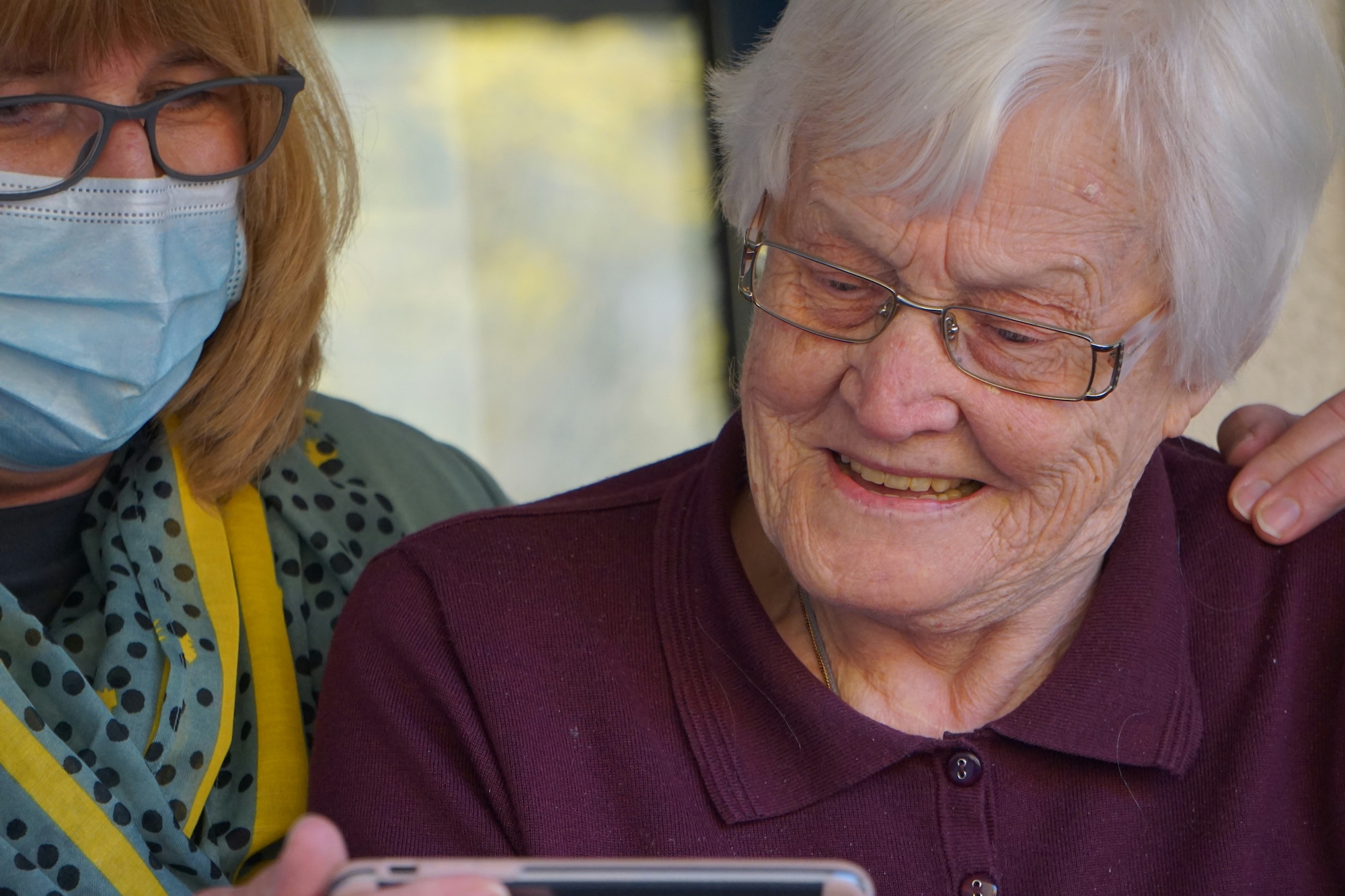 Elderly woman looking at relatives over zoom