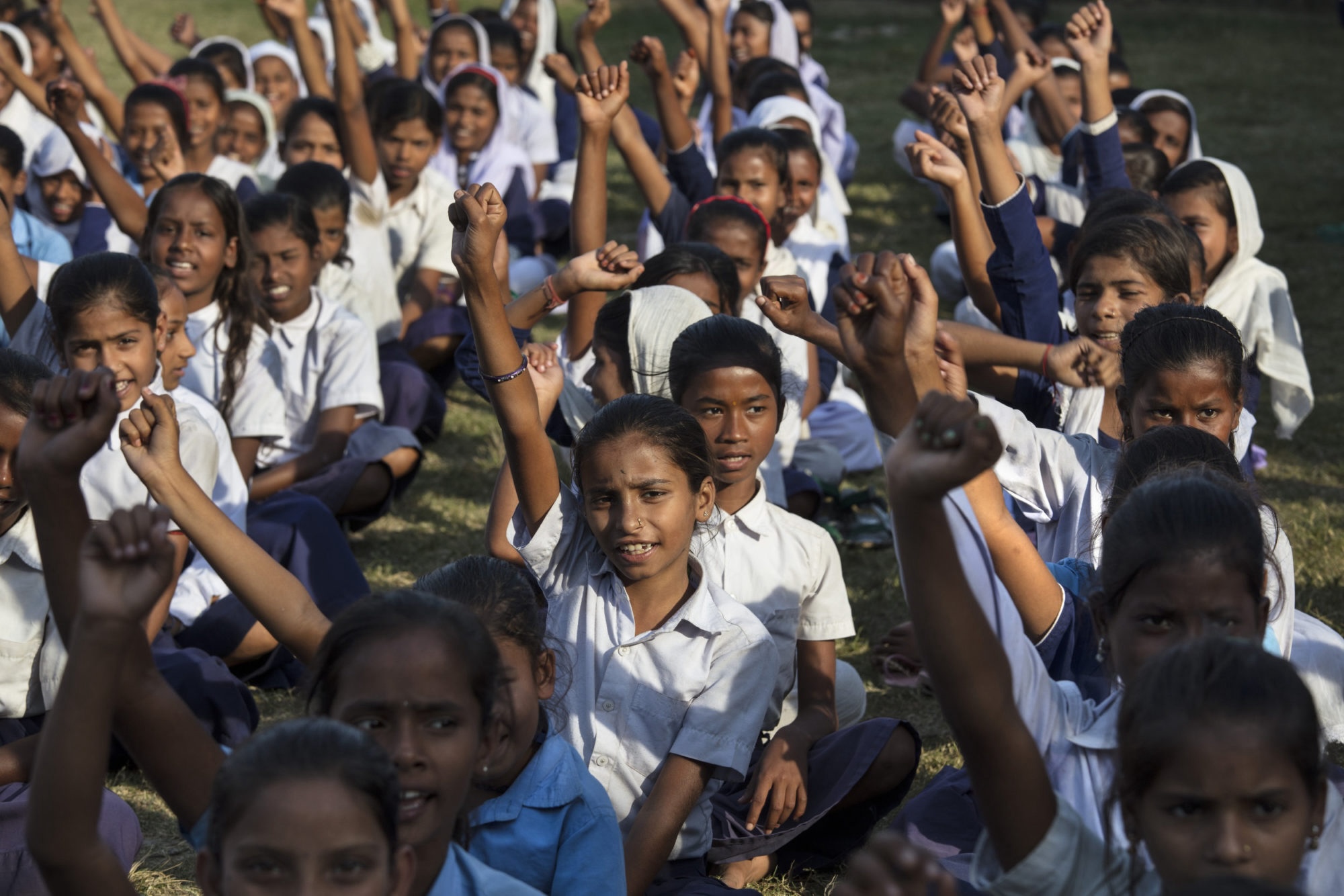 Girls raising their hand in class