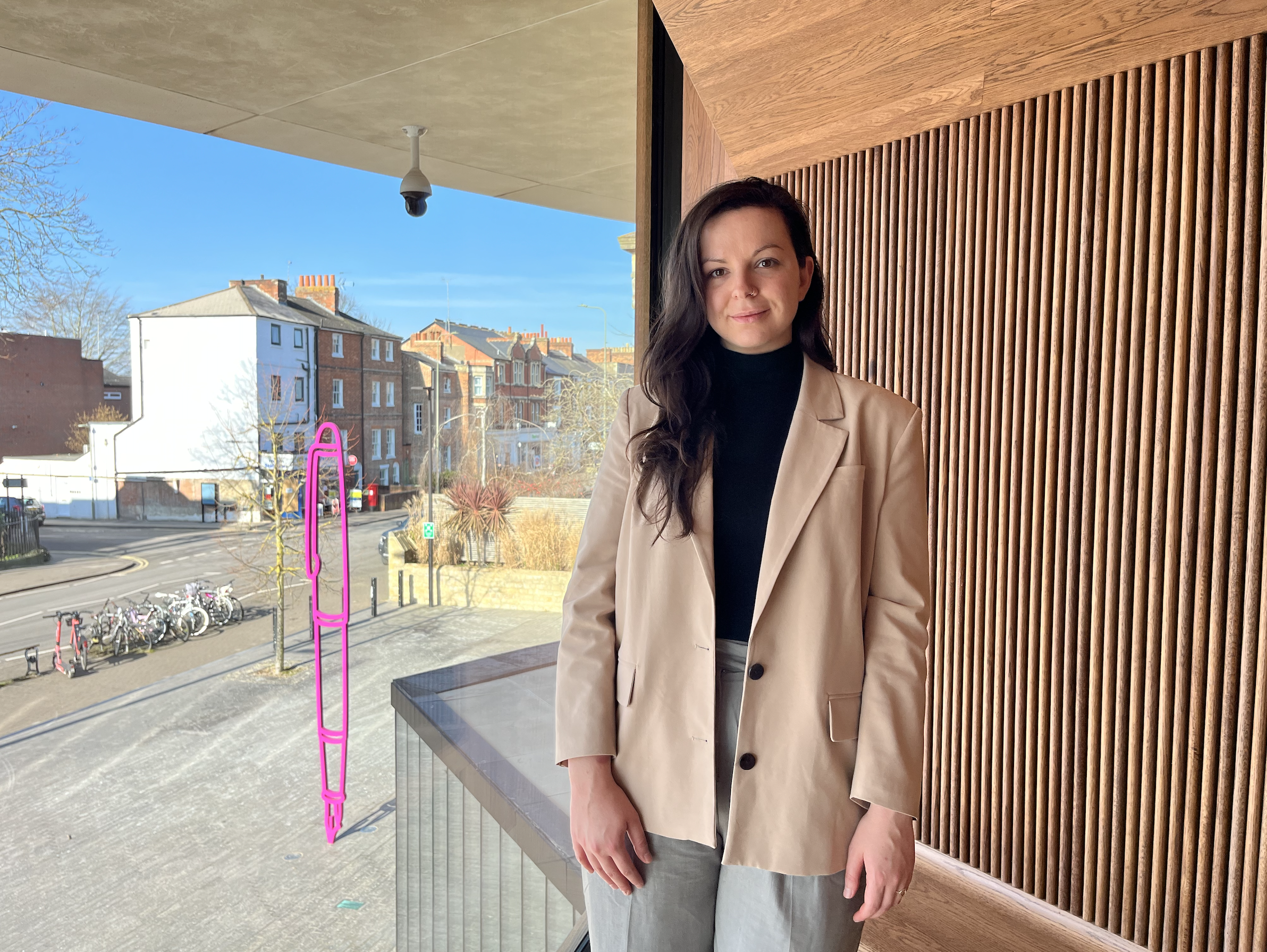 Image of MPP student, Emma, in front of the window to the world at the Blavatnik School