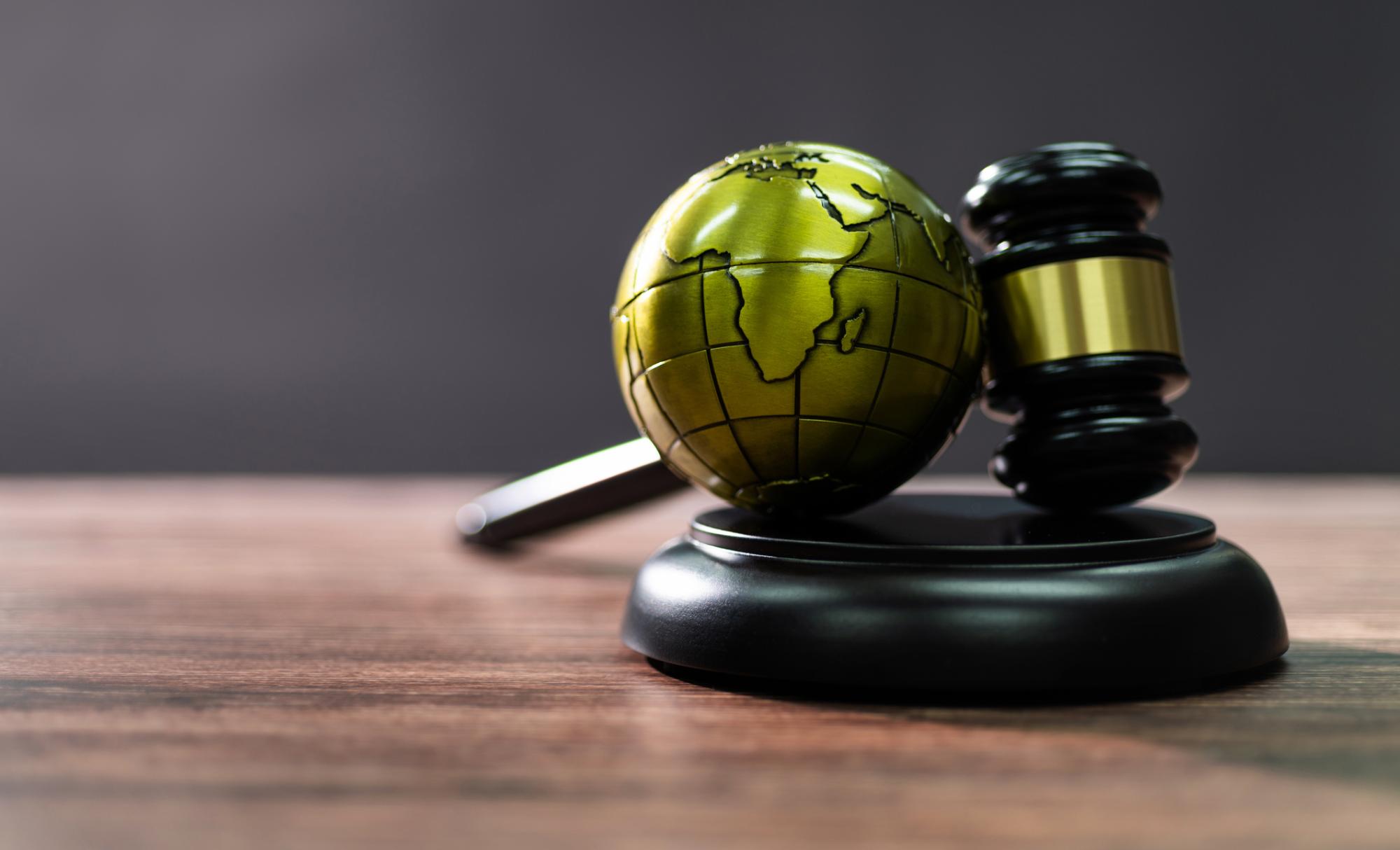 A globe and a judge's gavel (representing international law)