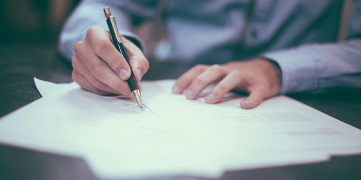 Close up of someone signing a contract