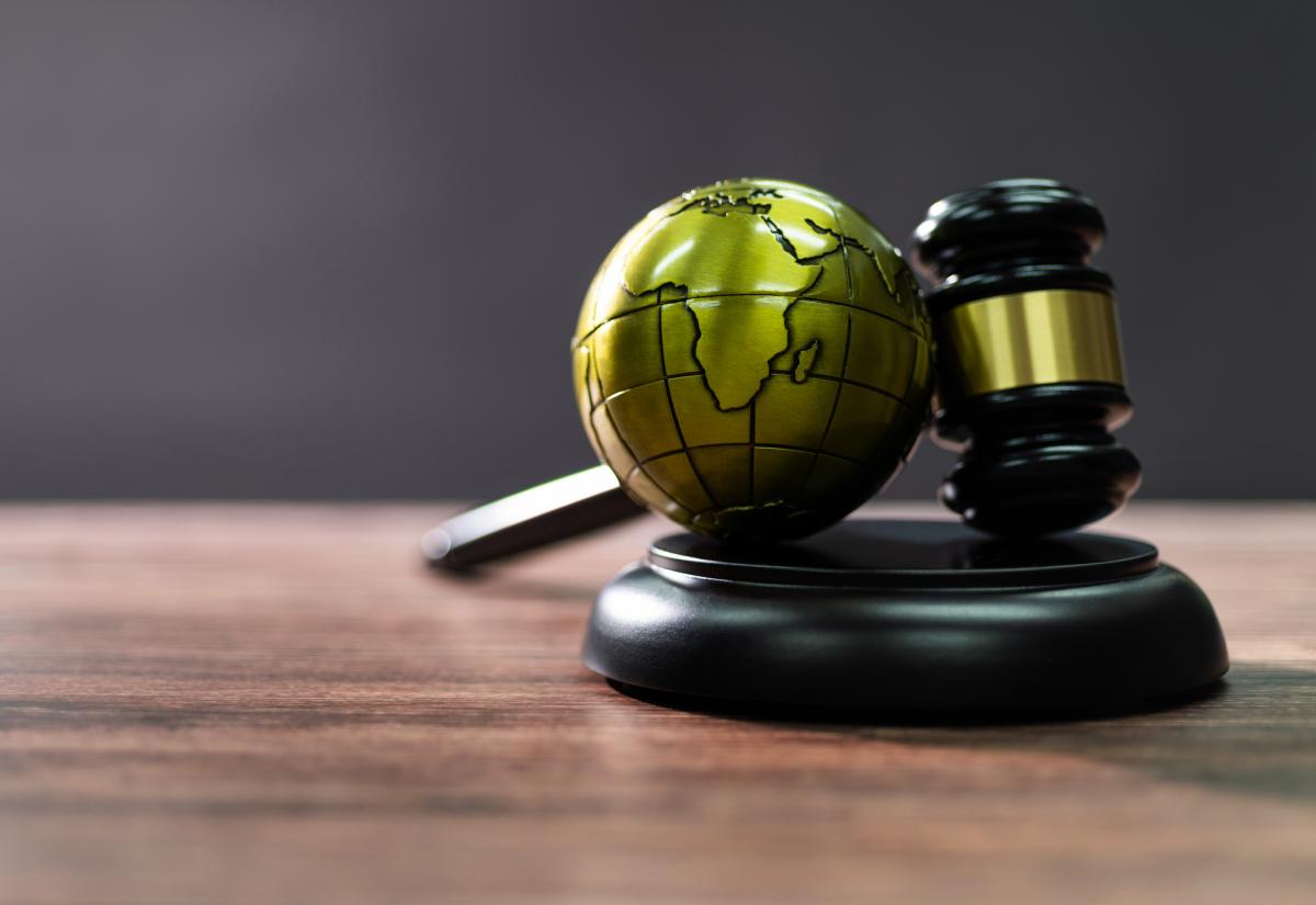 A globe and a judge's gavel (representing international law)