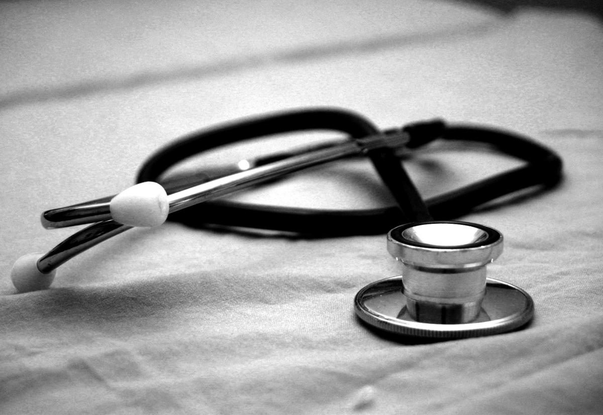 Black stethoscope on some white sheets
